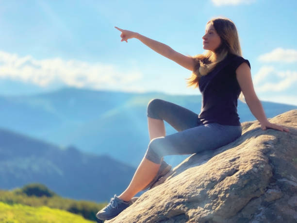 istock Young woman sits on a stone mountain, Ukraine 1495925236