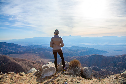Woman standing at Keys View in enjoying the beautiful mountain and valley view Coachella Valley in Joshua Tree National Park