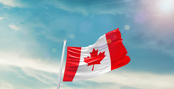 Canada national flag waving in beautiful sky.