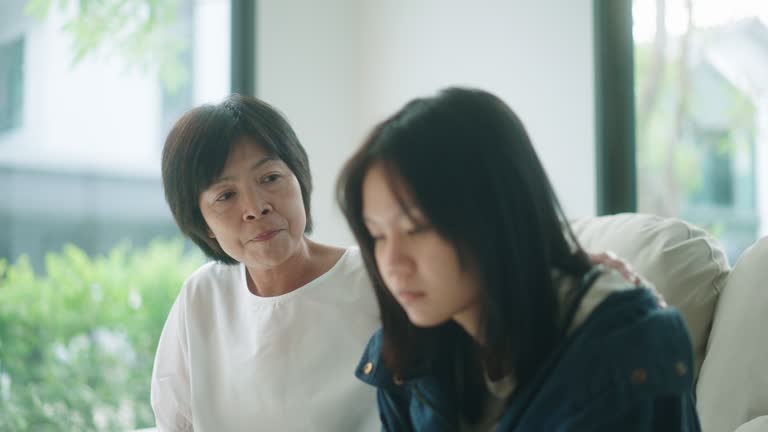 Mother consoling her daughter at home.