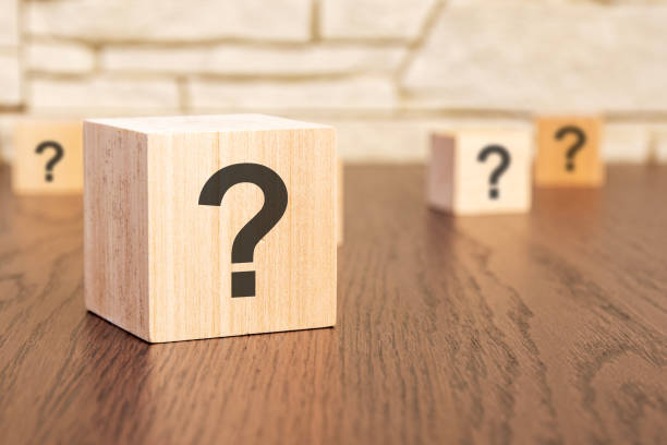 istock wooden blocks with question marks on wooden table, close up. space for text 1495936893
