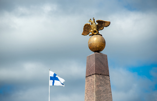 obelisk with Double-headed eagle and the flag of Finland in Helsinki