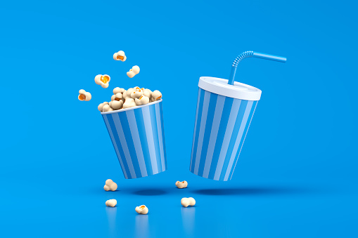 cardboard glass blue with popcorn on a white transparent background close-up