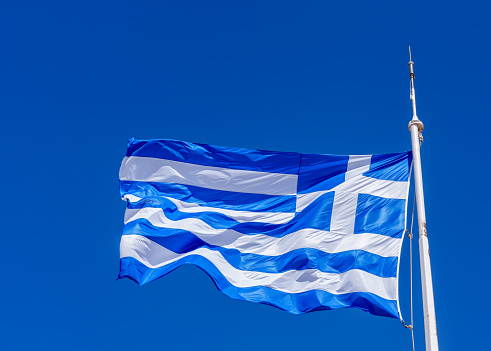 fluttering in the wind Flag of Greece on the ship floats in sea