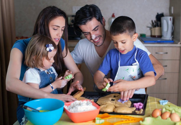 istock Happy family baking cookies 1495942146