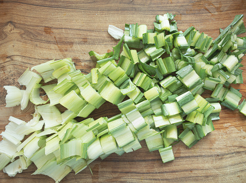 Fresh celery on a cutting Board. On wooden background