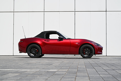 Berlin, Germany - 20 May, 2023: Mazda MX-5 parked on a public parking. This model is one of the most popular convertible vehicles in the world.
