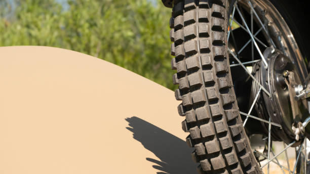 Off road parked motor bike close up of the rear tire from behind