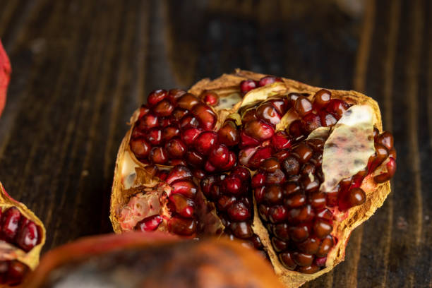 istock Rotten spoiled red ripe pomegranate on the board 1495951053