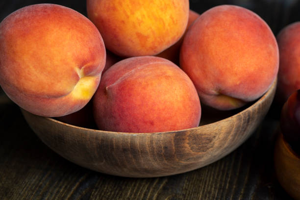 istock Ripe fresh peaches on a wooden table 1495951177