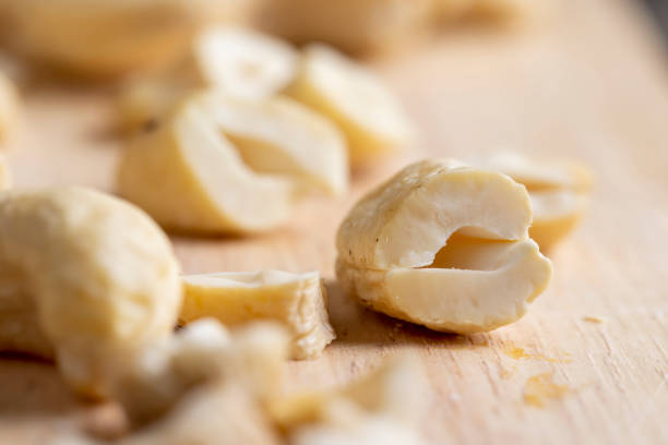 Hard roasted and peeled cashew nuts on the table, delicious cashew nuts on a wooden surface