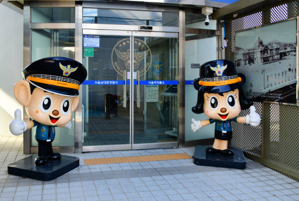 Open arms welcome to the Seoul Station Police Box, Namdaemun Police Station, Seoul, Seoul, South Korea: cute and friendly figures at the entrance to Seoul Station Police Box of the Namdaemun Police Station - Seoul Metropolitan Police (one of 16 provincial sub-divisions of the National Police Agency) - gwiyeopda / kawaii aesthetic. korean doll stock pictures, royalty-free photos & images
