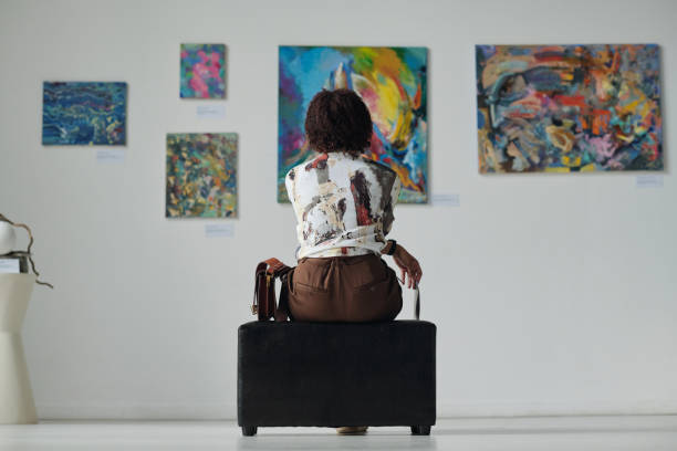 Woman enjoying art in gallery stock photo