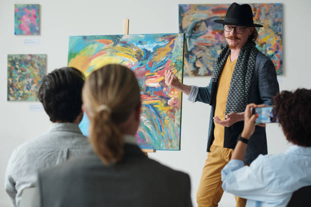 istock Artist presenting his picture at exhibition 1495955802