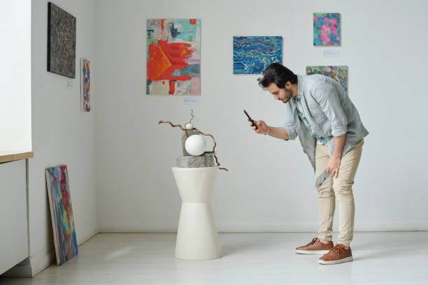 istock Man making photo of modern art 1495955860