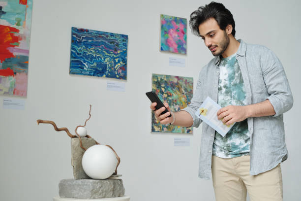 istock Visitor making photo of modern artin gallery 1495955880