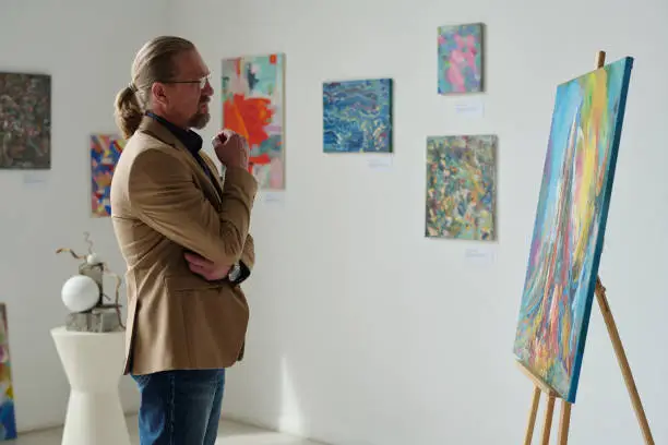 Photo of Man enjoying the modern art in gallery