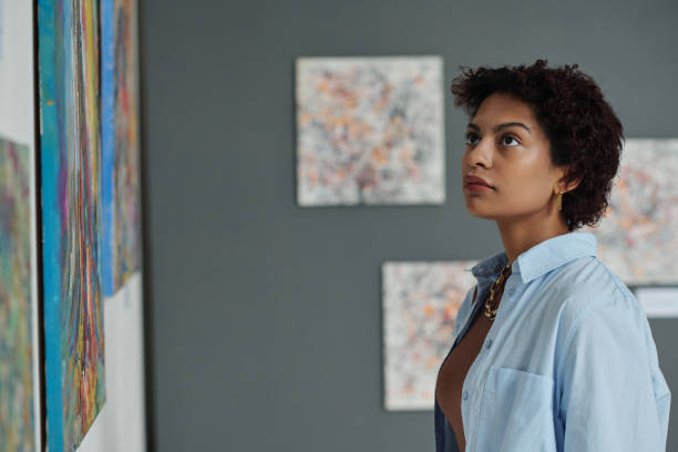 istock Young woman visiting art gallery 1495956006