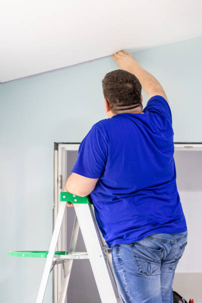 istock A man removing masking tape after painting 1495956090