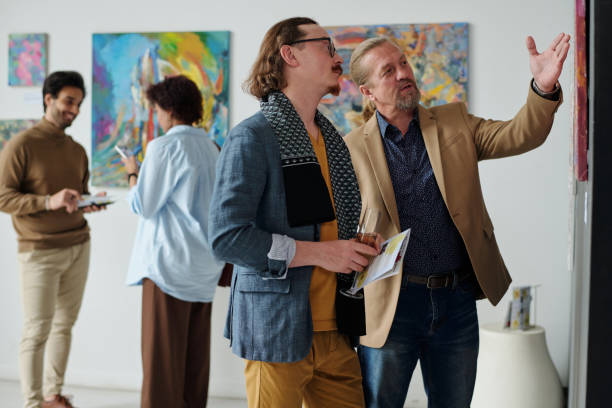 istock Art lovers discussing modern art in gallery 1495956106