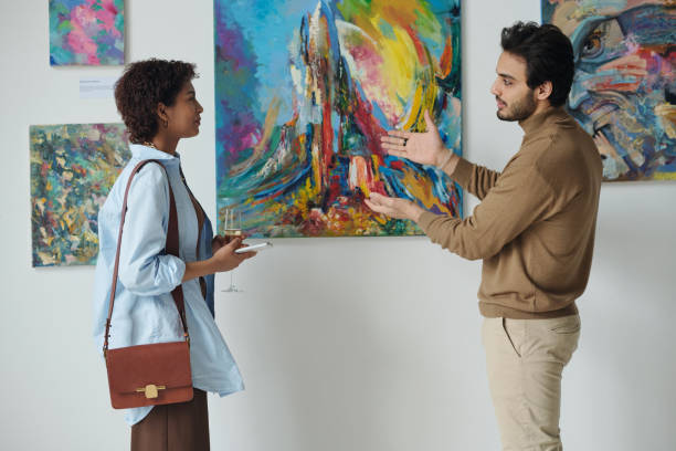 Man discussing art with woman stock photo