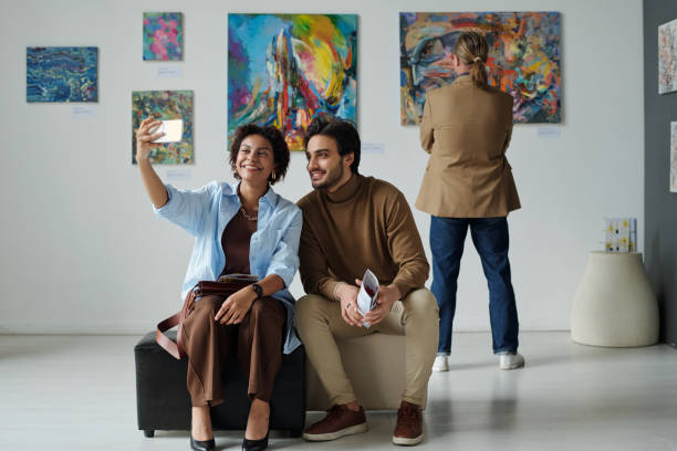 istock Couple making selfie portrait in gallery 1495956176