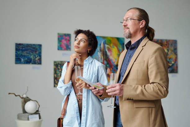 istock Art lovers enjoying modern art in gallery 1495956268