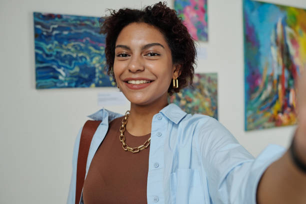 istock Woman making selfie portrait in gallery 1495956356