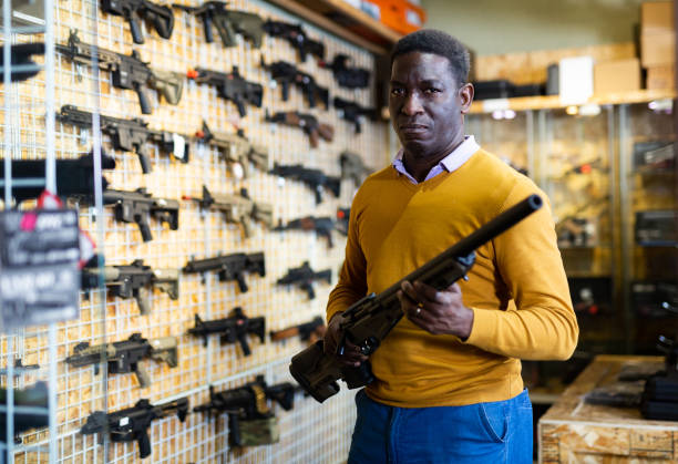 istock Man with hunting rifle in weapon shop 1495963149
