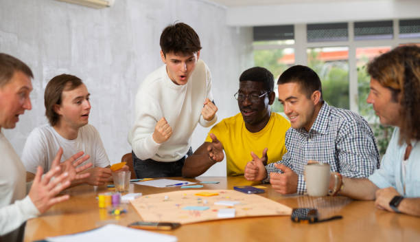 istock Group of men play board games 1495963289