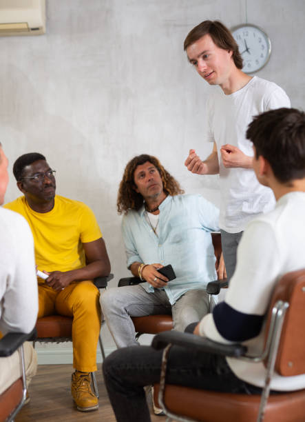 istock Young man teacher reading lecture for a group of guys 1495964171