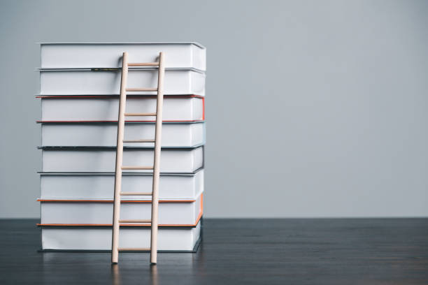 istock A studying climbing up to the book stack. A concept of education process. Copy space for text. Distance education, e-learning concept. scale that reaches knowledge and freedom. 1495965860