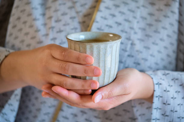 istock Hands holding japanese green tea. 1495966330