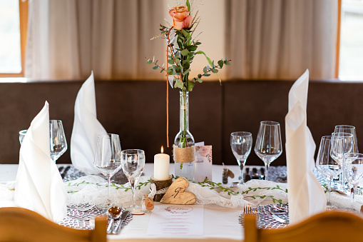 Decorated Gala dinner table with wine glasses and decorative napkins for a wedding