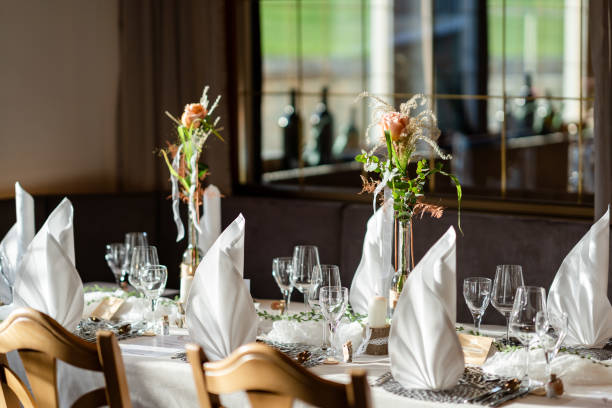 istock Decorated Gala dinner table with wine glasses and decorative napkins for a wedding 1495971571