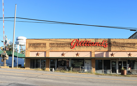 An old storefront with the original red signage in Livingston, Texas