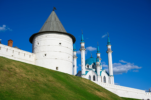 Kazan Kremlin in summer, Tatarstan, Russia. It is top landmark of Kazan. Scenery of white wall, tower and Kul Sharif Mosque under blue sky. Historical place in old Kazan city center. UNESCO site.