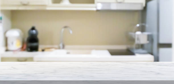 istock white marble stone counter top with blurred kitchen background 1495981627