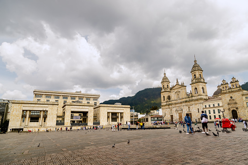 Bogota, Colombia - January 1, 2023: Some tourists gather in the Plaza de Bolivar, the main square of Bogota