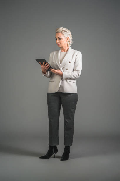 istock Serious Mature Caucasian Female Using A Digital Tablet 1495985096