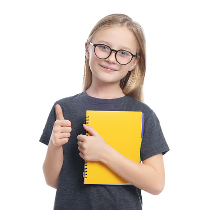 Cute girl in glasses with books showing thumb up on white background