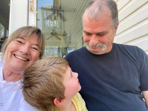 istock Grandparents laughing with grandson 1495988897