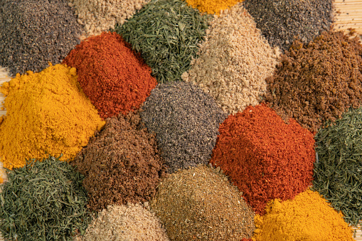 Assortment spices and herbs for cooking. Spice and seasoning. Various fragrant spice market. Heap different Asian Spices lies on wooden background