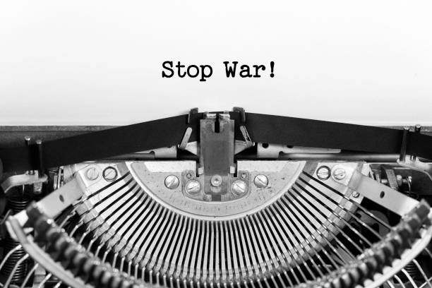 stop war phrase closeup being typing and centered on a sheet of paper on old vintage typewriter mechanical - violence newspaper crime newspaper headline imagens e fotografias de stock