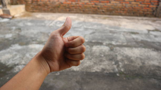 istock asian man hand in thumbs up pose 1495997142