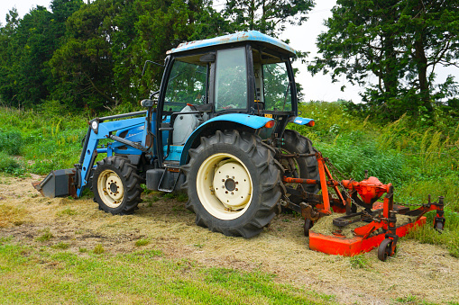 Tractor machine stopped in a green field