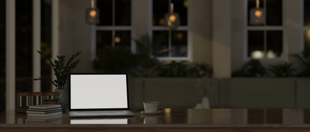 istock A laptop white screen mockup on a tabletop in modern comfortable room at night. 1496002694