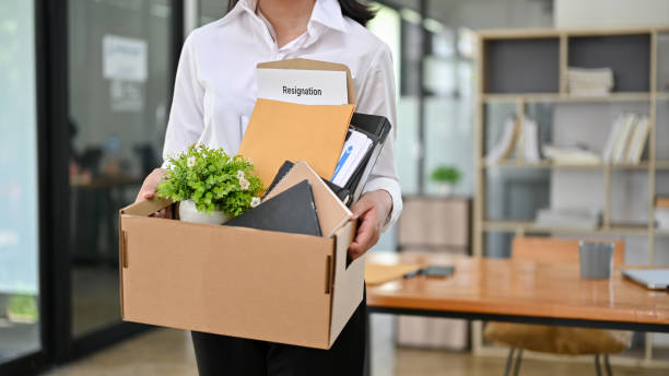 istock A female office worker with a cardboard box with her stuff and her resignation letter. 1496002910
