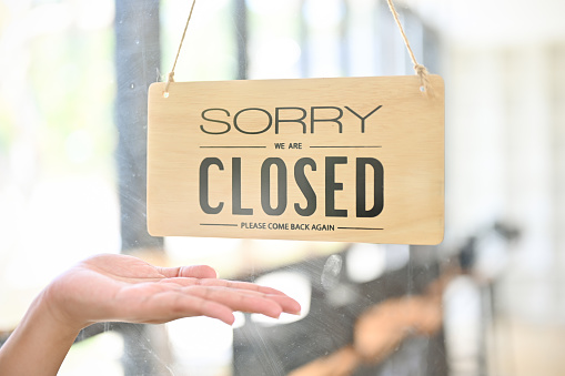 Close-up image of a coffee shop or restaurant front door with close sign.