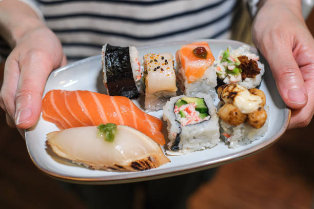 home made japanese sushi and nigiri in one plate which mix variety of sushi. - food dinner prepared fish gourmet imagens e fotografias de stock